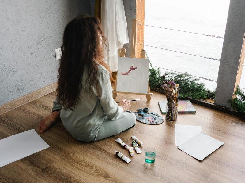 Child painting and sitting on a luxury vinyl floor